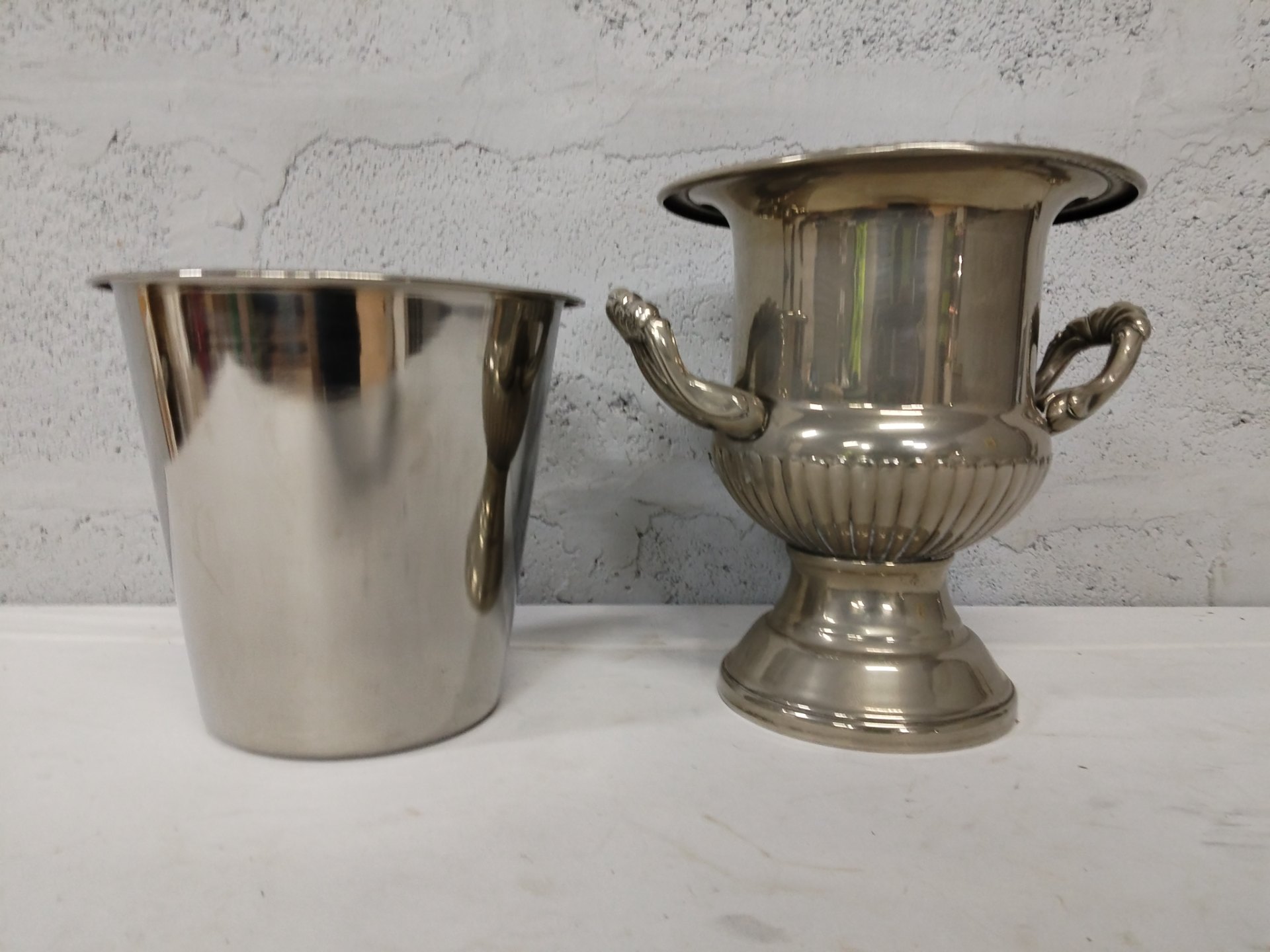 Pair of silver‑plate wine / champagne coolers — plain bucket (rim crack) + decorative two‑handled urn