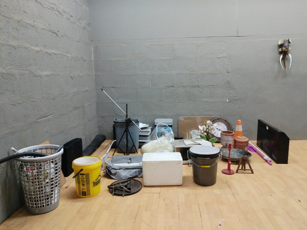 Mixed household & DIY lot — microwave, heater/AV unit, tripod, pots, buckets, clock & more (approx. 25 items)