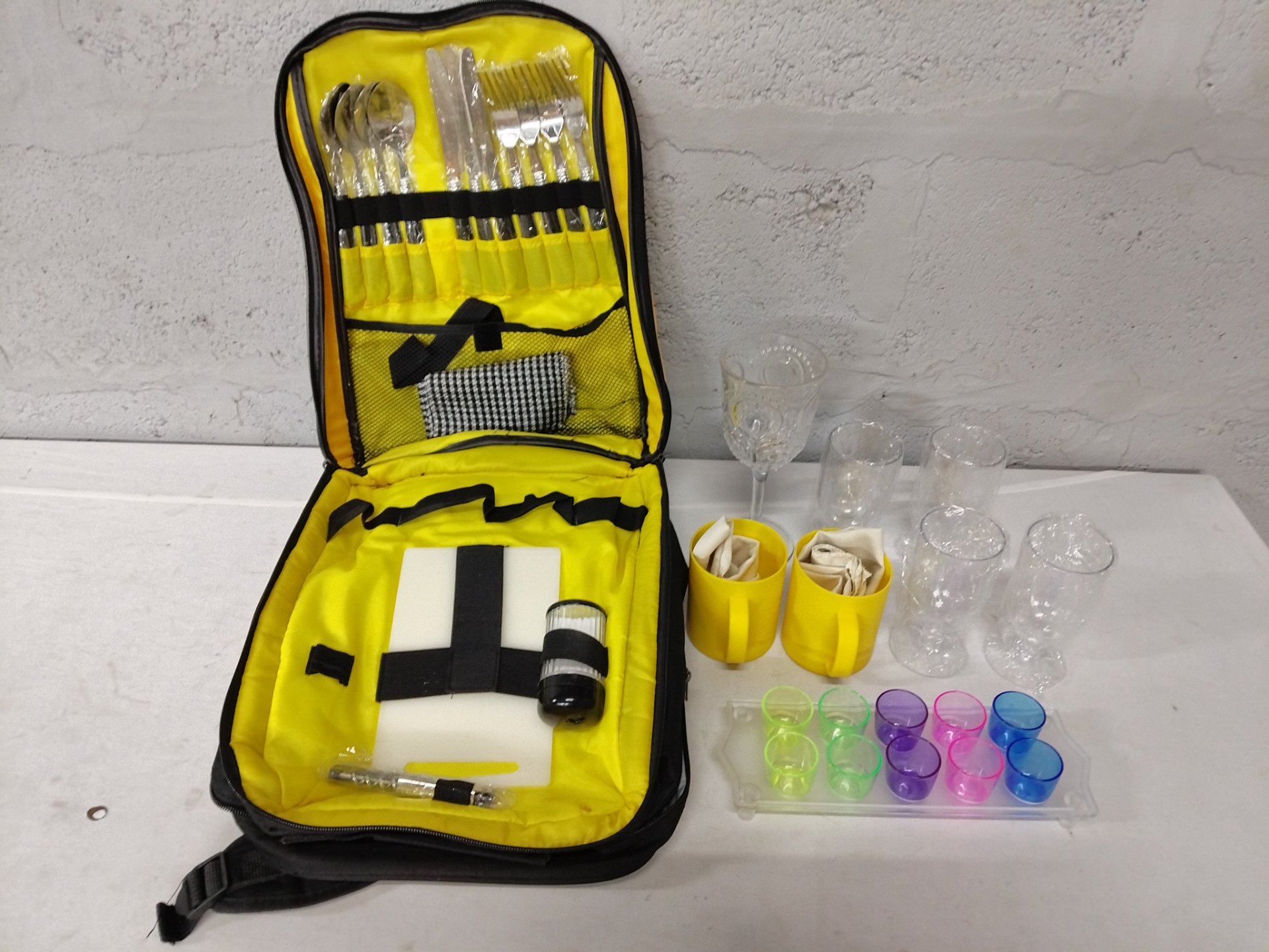 Picnic cutlery & drinkware kit in black/yellow backpack — 19pc mixed set (12pc cutlery, glasses, shot cups, mugs, plates)
