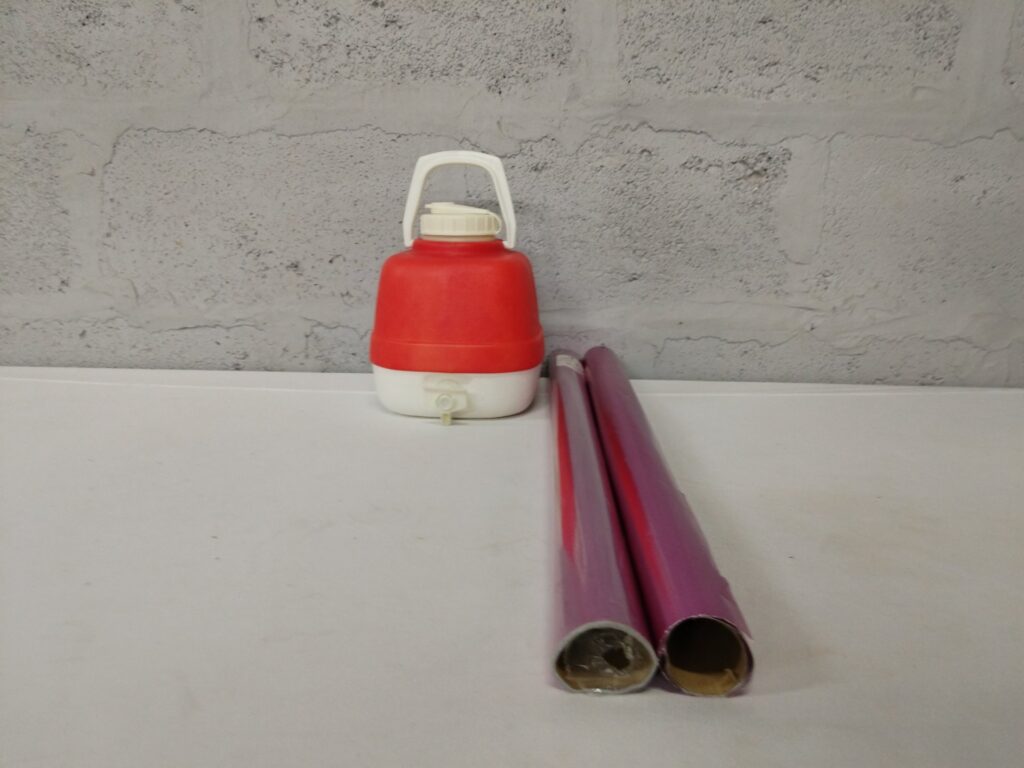 Mixed lot: Red/White Plastic Water Jug Dispenser (tested) + 2 x Pink Metallic Gift Wrap (4m)