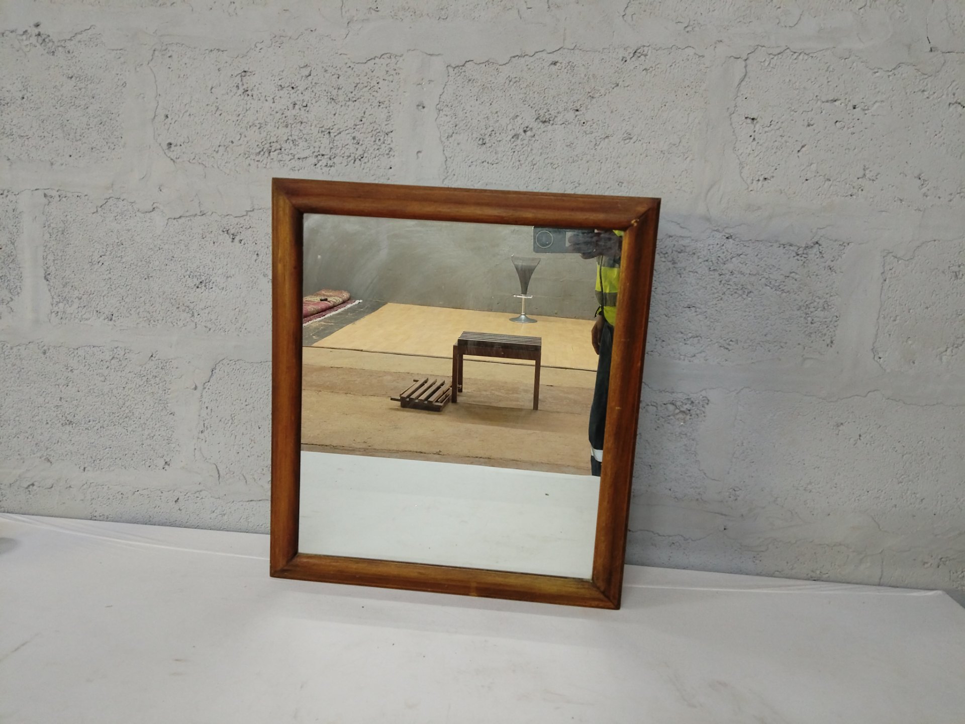 Wall-mounted wooden medicine cabinet with mirrored door, internal shelves — worn, mirror foxing