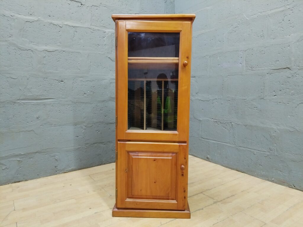 Tall pine storage/display cabinet with glass-front door and internal 3-column CD/DVD divider