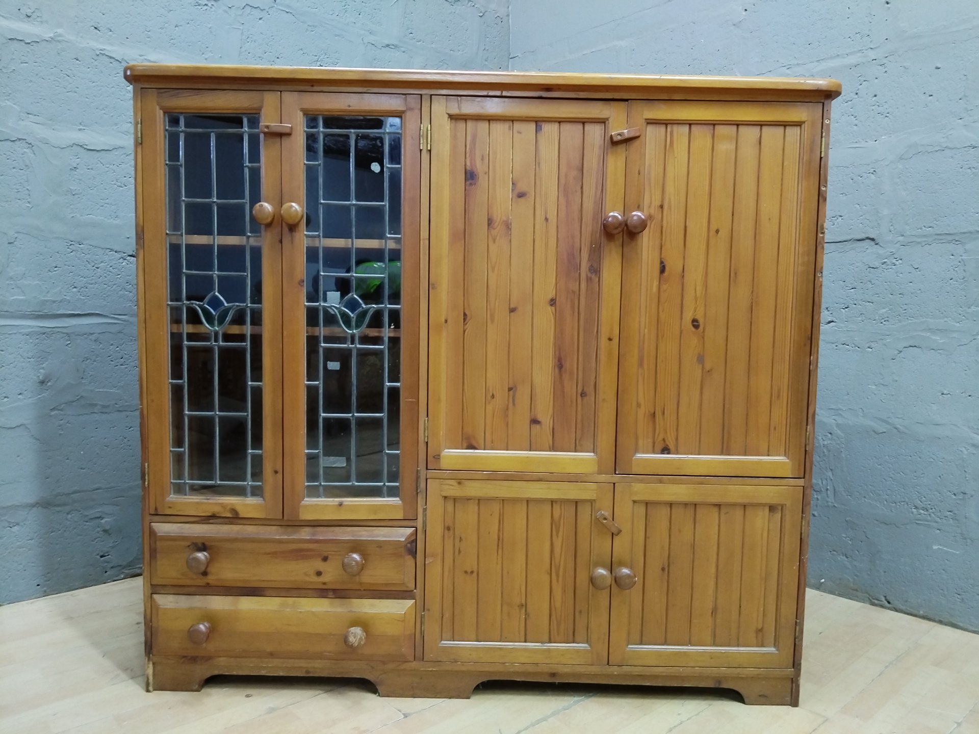 Pine display/storage cabinet with leaded glass doors, shelves & drawers