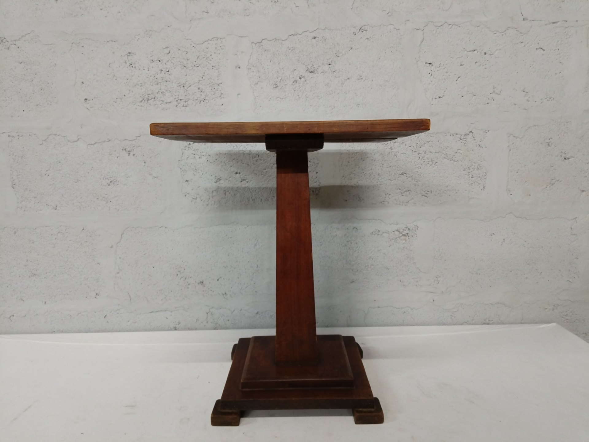 Wooden pedestal side table with stepped square base — compact lamp or project table