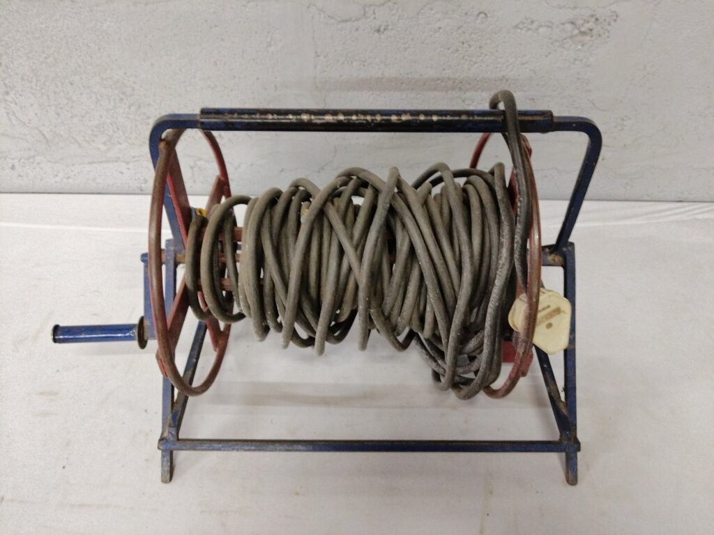 Used Metal Hand-Crank Cable Extension Reel with Coiled Power Cable and Single Socket