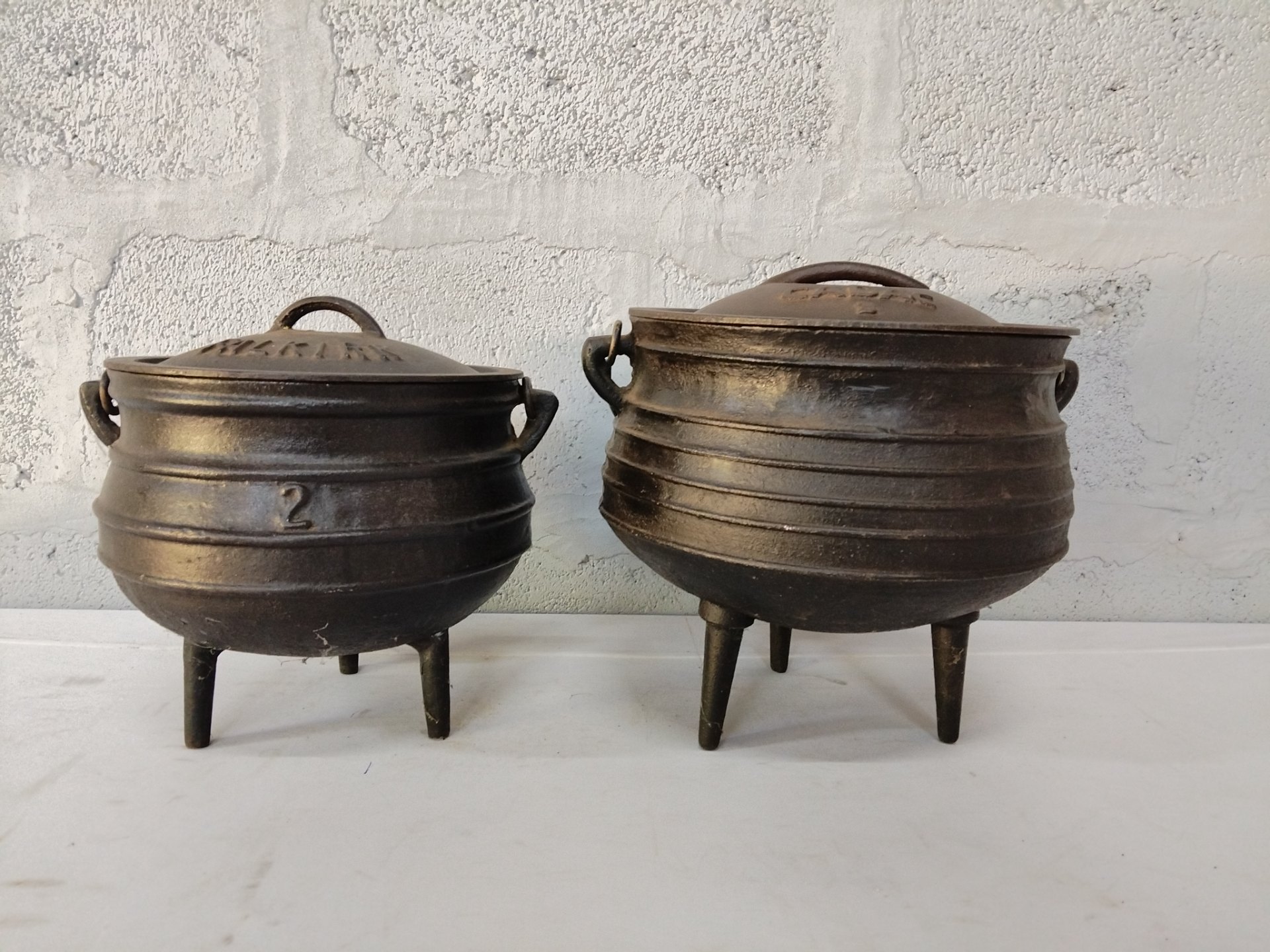 Pair of Cast‑Iron Three‑Legged Potjie Pots with Lids — CADAC & FALKIRK marked
