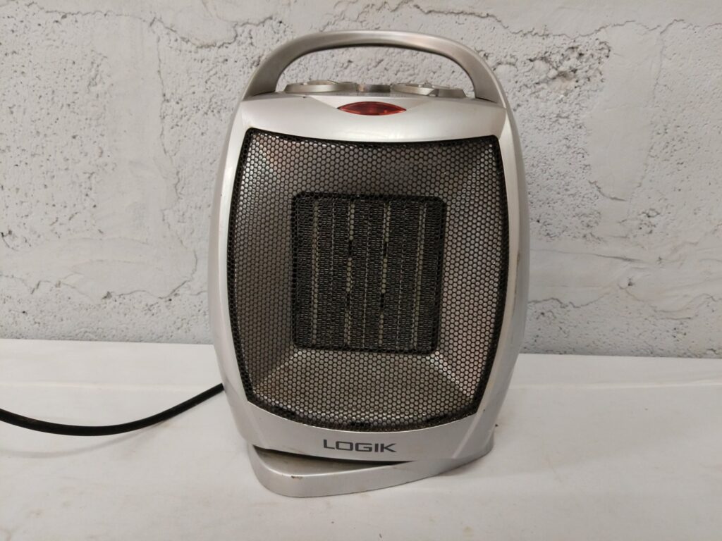 Logik PTC Fan Heater PTC-1502 (1500W) — portable ceramic heater, used with cracked casing