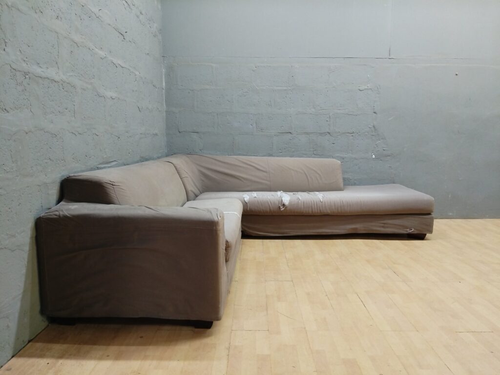 Large L-shaped brown fabric sectional sofa – heavy upholstery damage, separable for transport