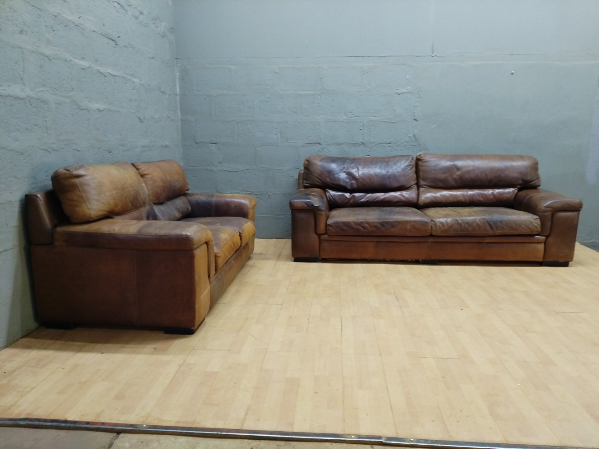Pair of brown top-grain leather sofas — 3-seater (247 x 93 x 89 cm) + 2-seater (182 x 93 x 89 cm) — heavy wear / repairs needed