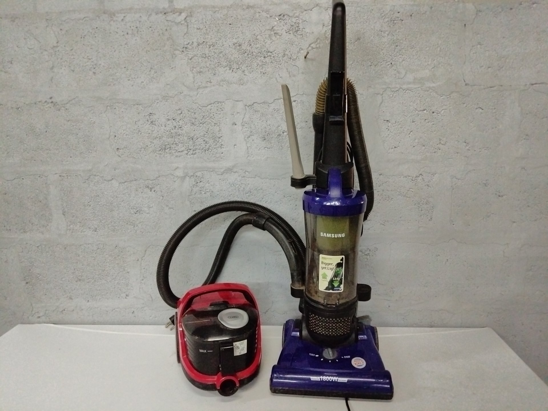 Pair of used vacuum cleaners — Samsung SU3350 upright (1800W) + Defy VC32801 canister (800W) — working, cosmetic wear