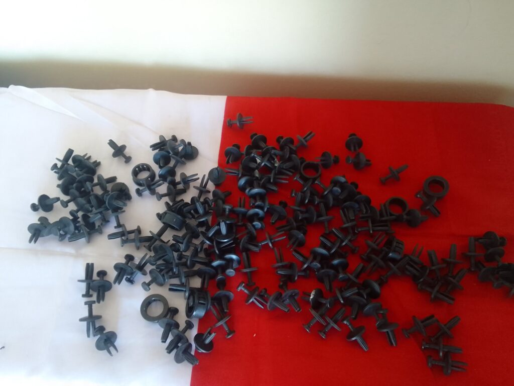 Large lot of assorted black plastic push rivets / trim panel clips (mixed types)
