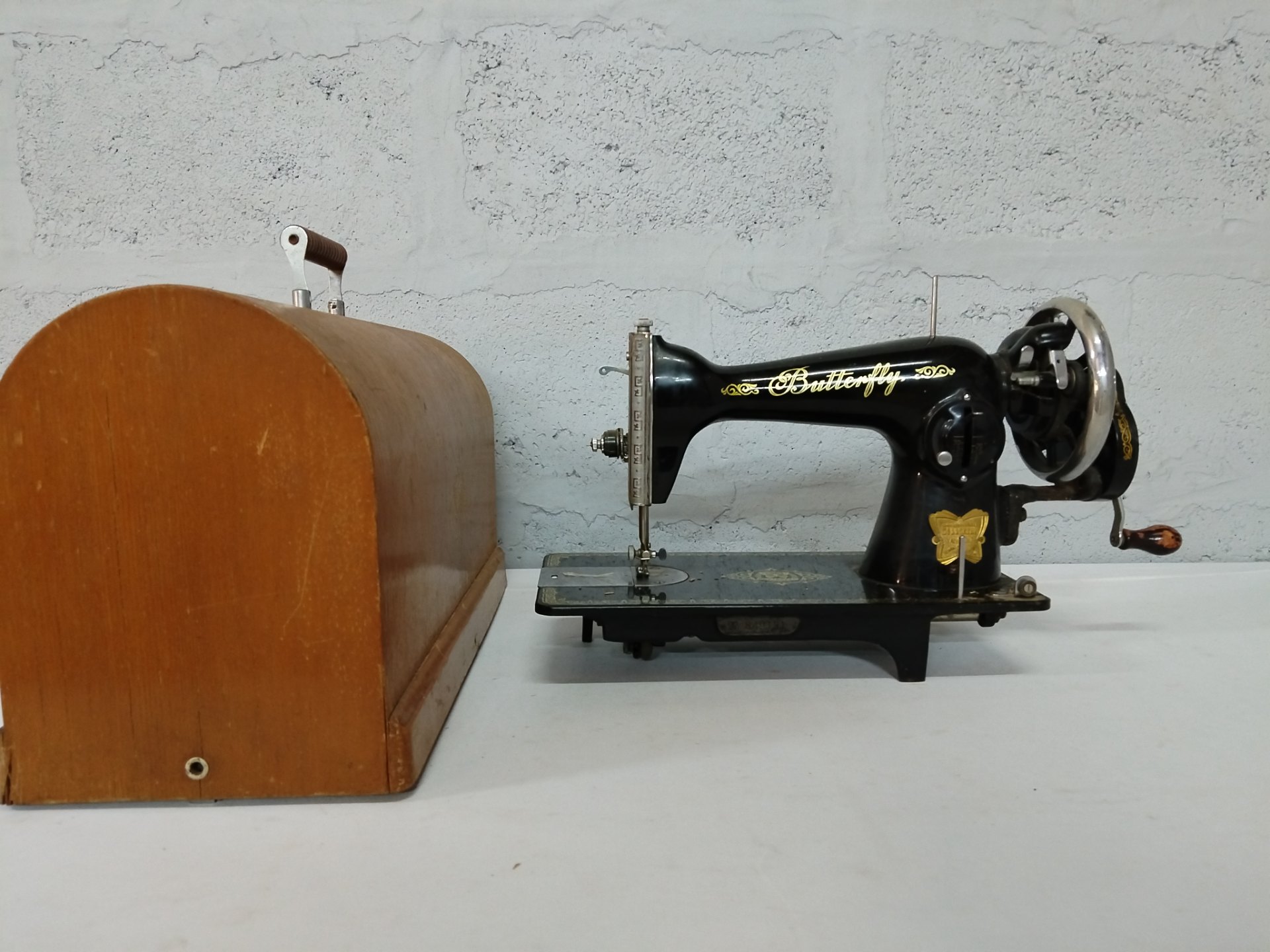 Vintage Butterfly hand‑crank sewing machine with wooden carrying cover — tested working