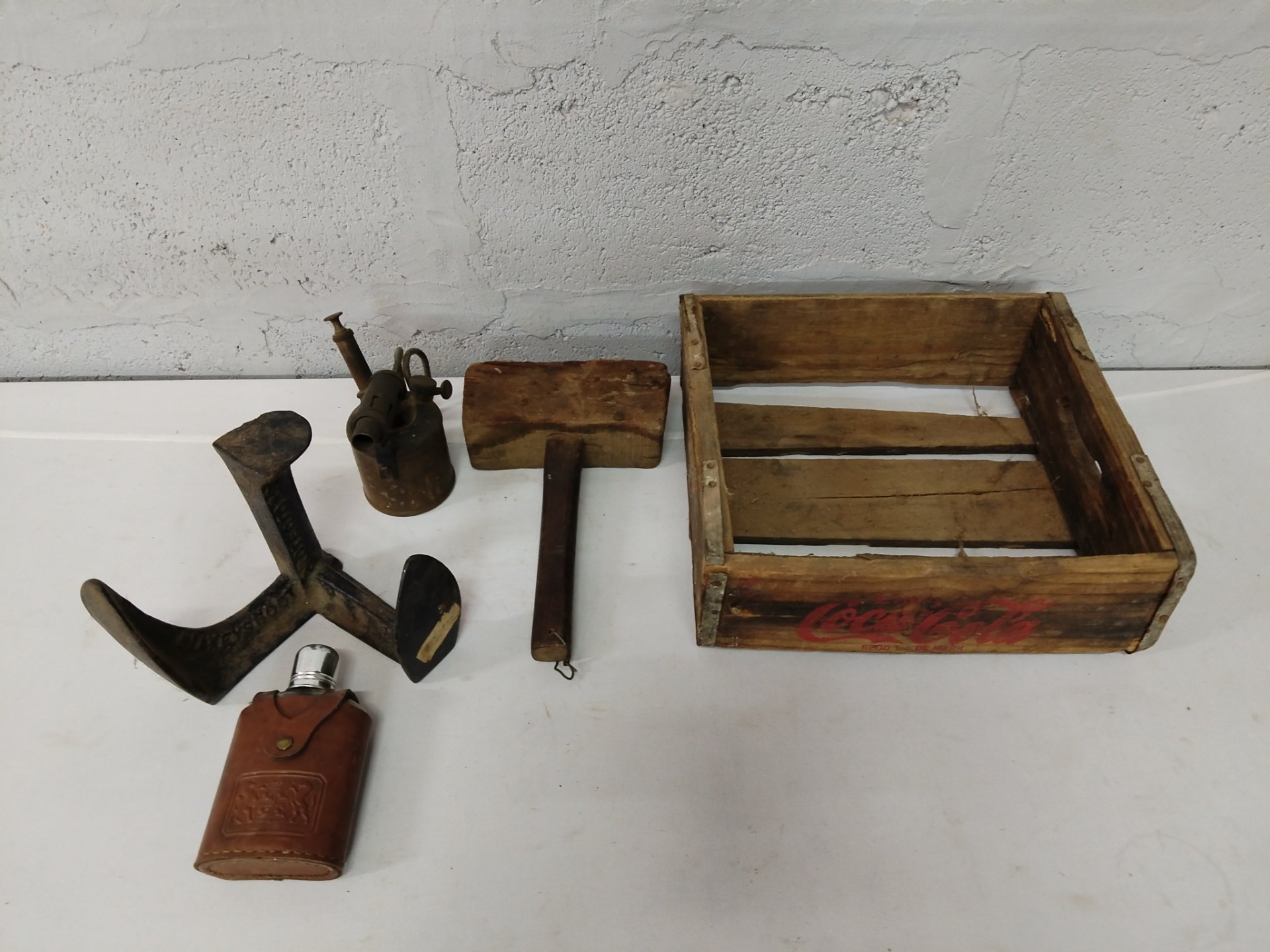 Mixed vintage tool lot with Coca‑Cola wooden crate, blowtorch, wooden mallet, shoe anvil & leather flask