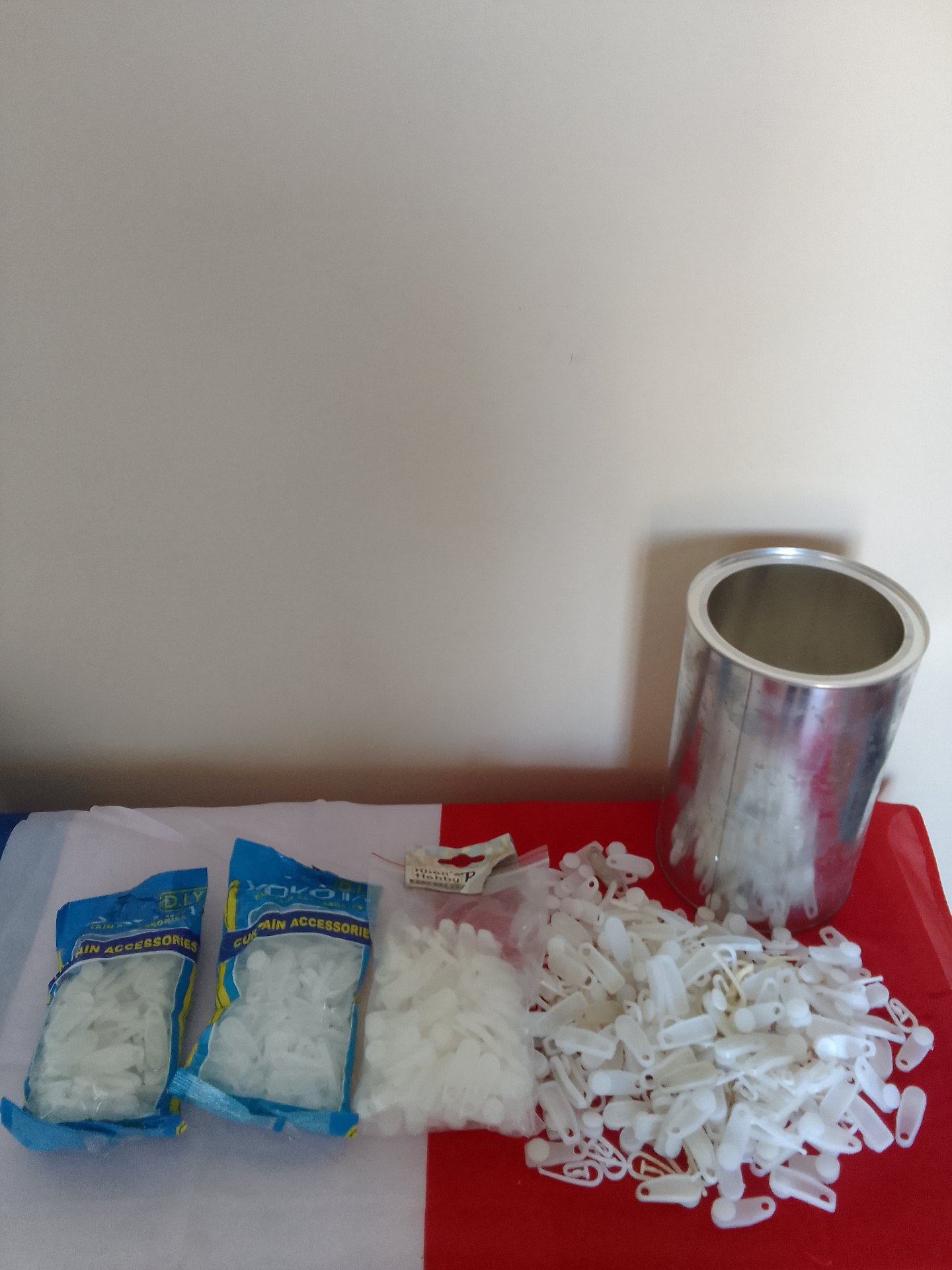 Large lot of white curtain accessories — sealed packs plus loose hooks (metal tube included)