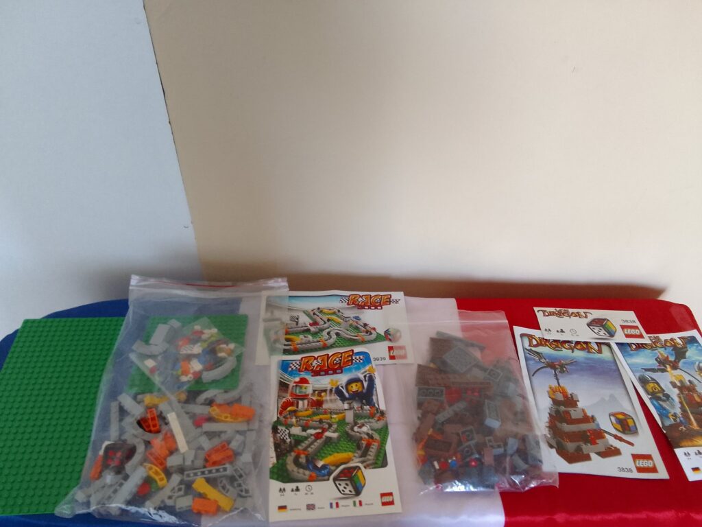 Mixed LEGO lot — bagged loose parts with Race and Dragon instruction booklets