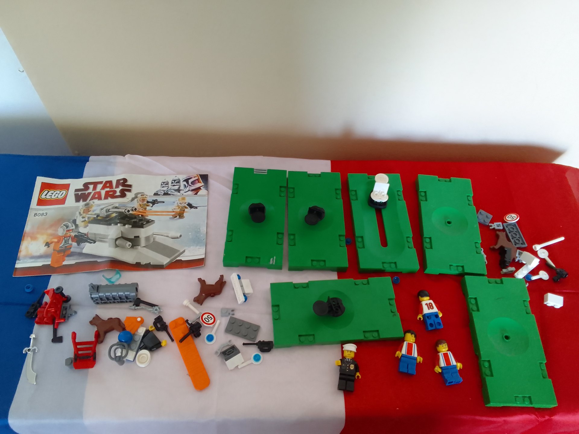Mixed LEGO parts lot with Star Wars 8083 instruction, minifigures and green base plates — used
