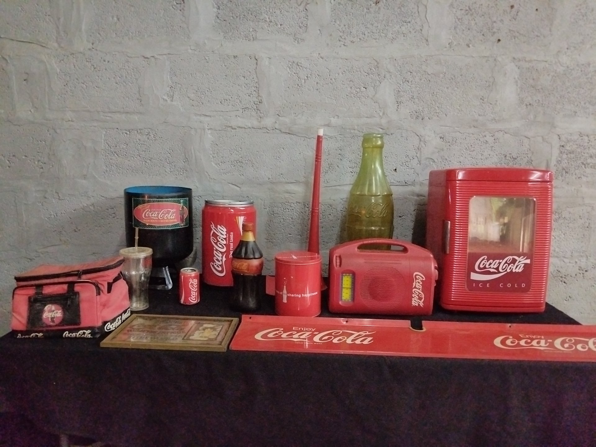 Assorted Coca‑Cola promotional memorabilia lot — mini ‘Ice Cold’ fridge, radio, tins, bottles & signage (used, not working)