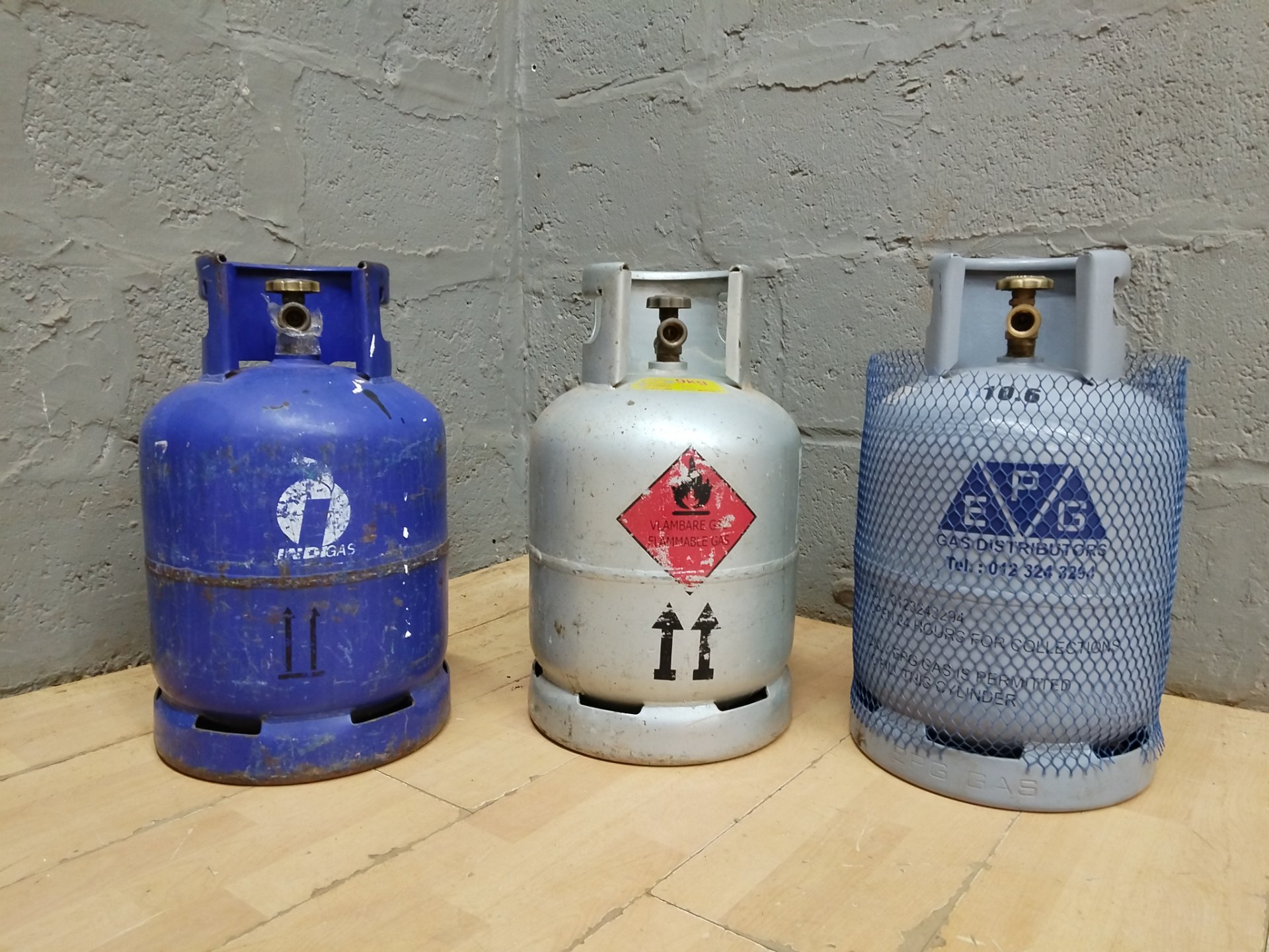 Lot of 3 LPG cylinders — valves present, pressure‑test stamps visible & within expiry, all empty