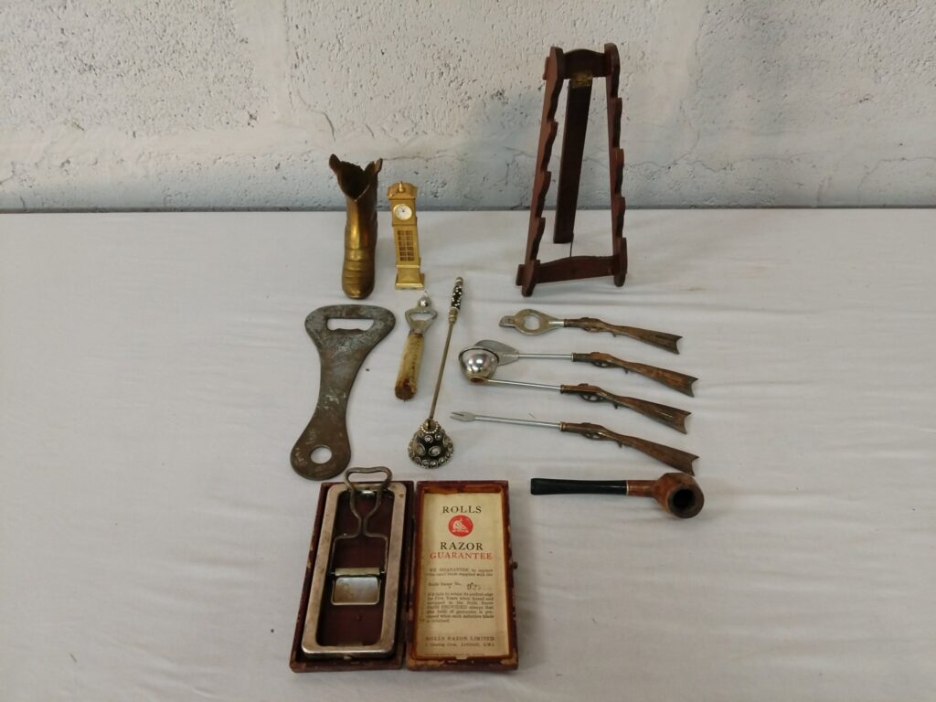 Mixed lot of 12 vintage novelty metalware – boxed Rolls Razor, bottle openers, gun-handle skewers, brass boot & clock, pipe and small wooden easel