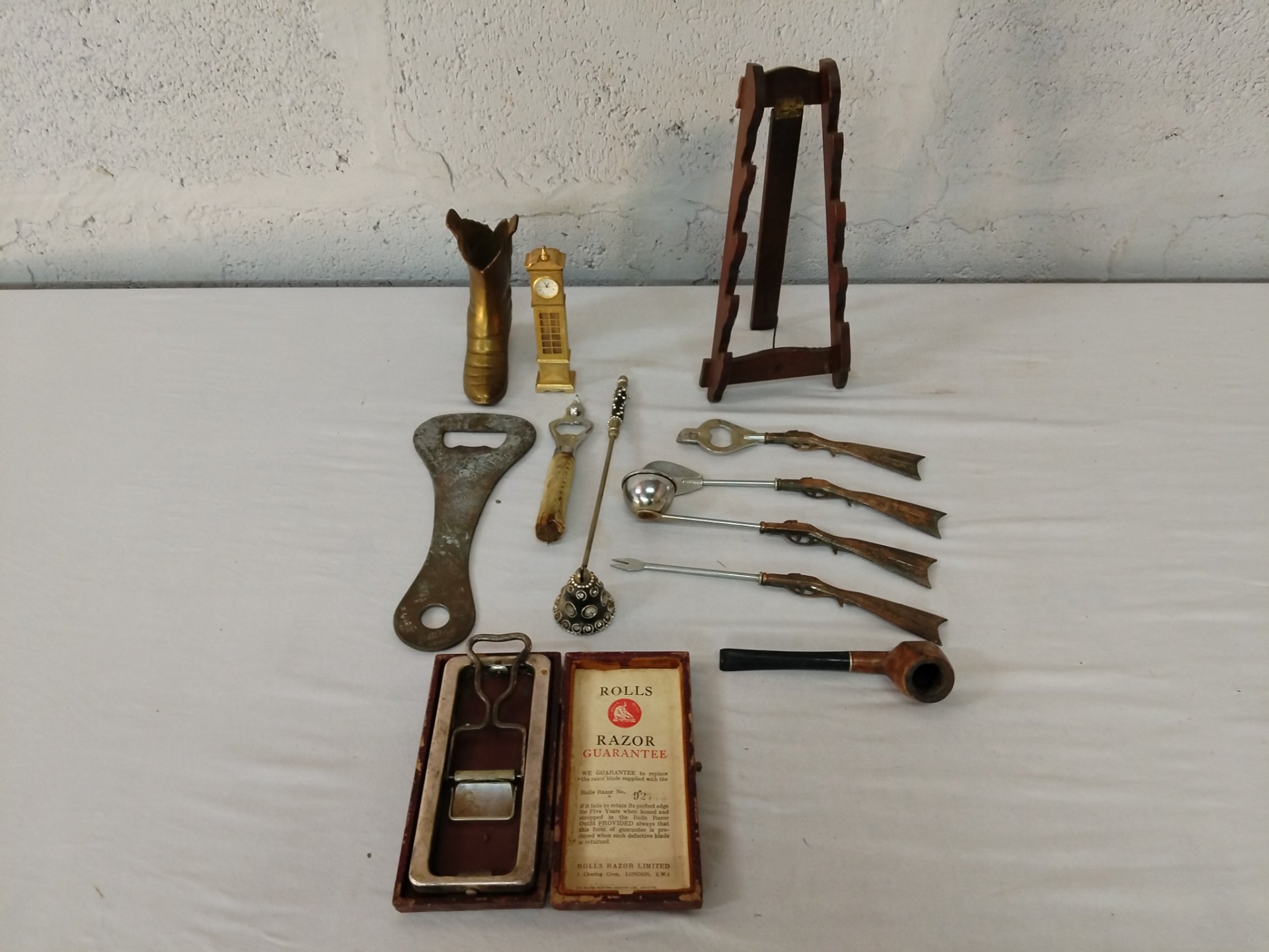 Mixed lot of 12 vintage novelty metalware – boxed Rolls Razor, bottle openers, gun-handle skewers, brass boot & clock, pipe and small wooden easel