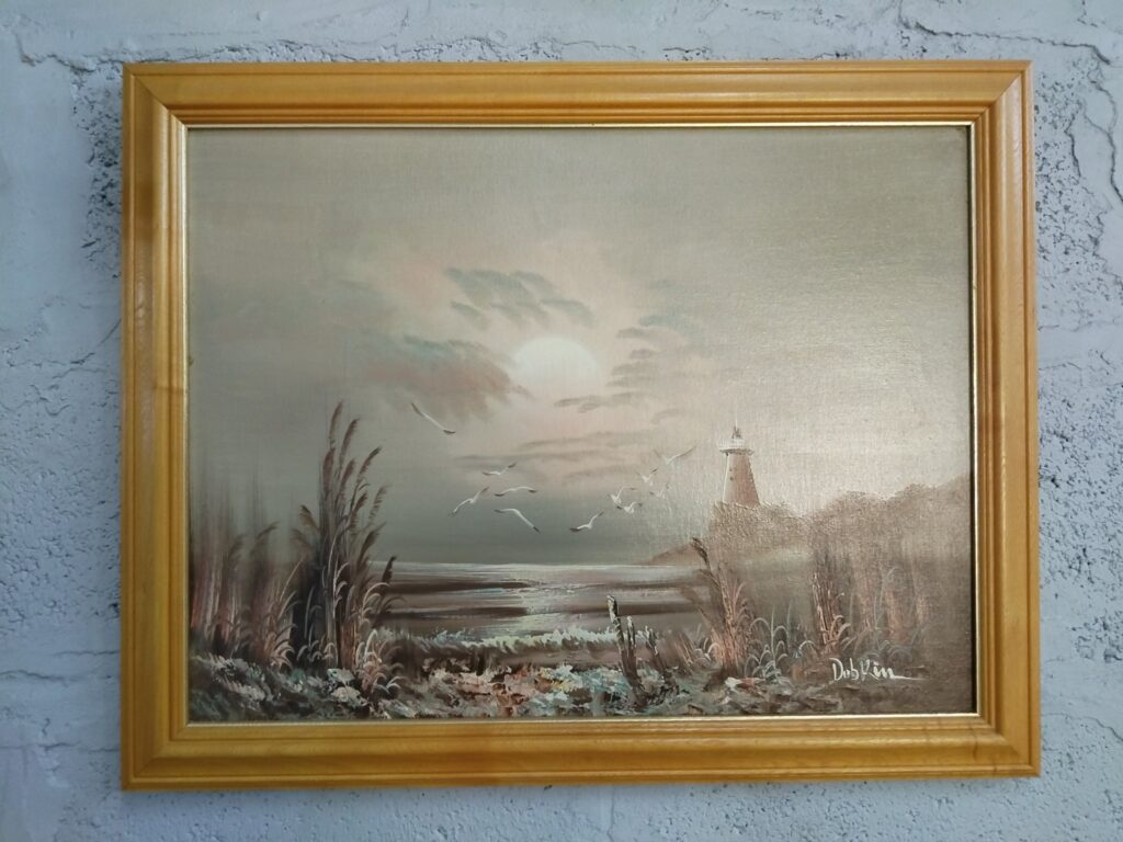 Signed seascape on stretched canvas in gilt‑tone wooden frame (70 x 56 cm framed)
