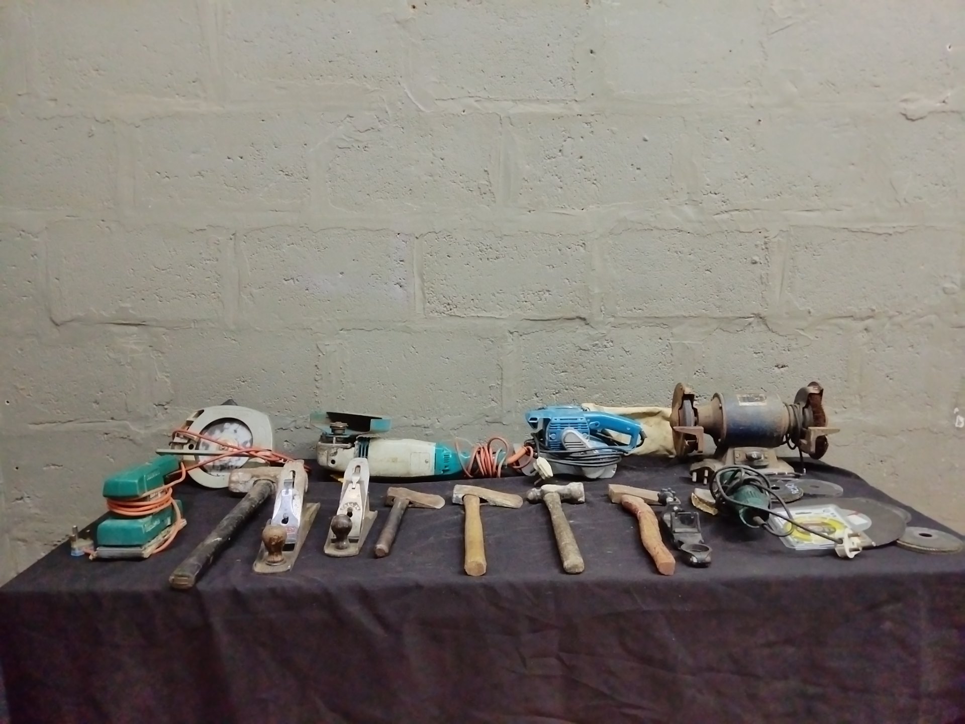 Bulk lot of 23 used hand and corded power tools — grinders, circular saw, planes, hammers, discs