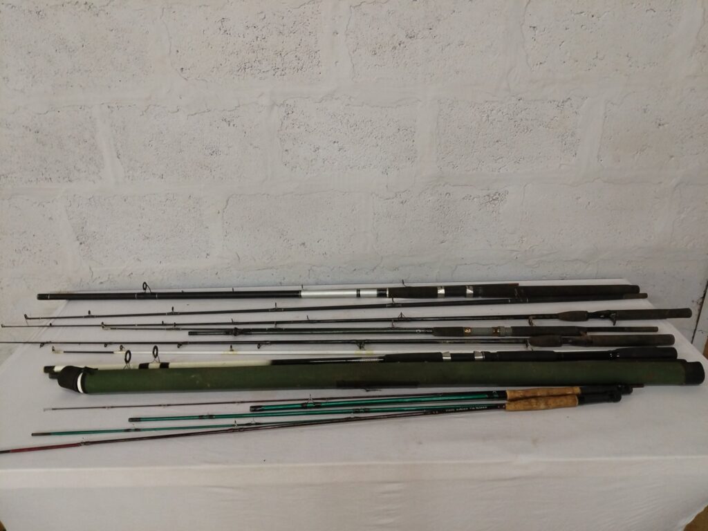 Lot of 8 used fishing rods & sections with green rod tube — mixed condition, some repairs
