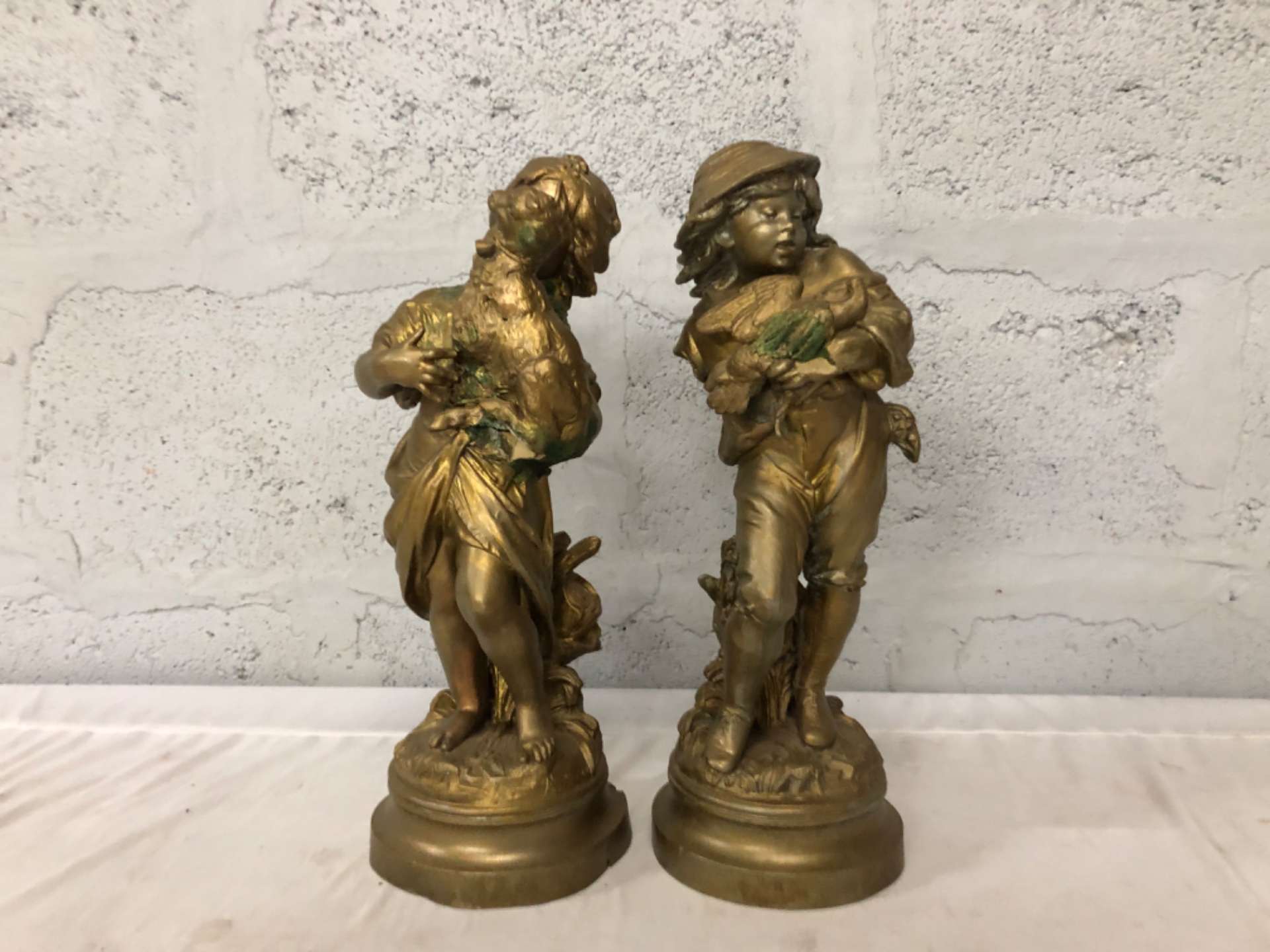 Pair of Gilt Figural Children — Metal (reported bronze/spelter) decorative statues, heavy verdigris, one base broken