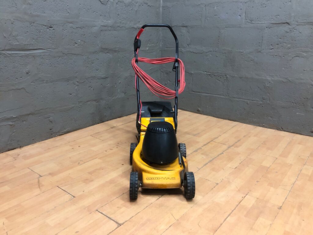 Mini-Vac corded electric lawn mower — working, grass collector attached, heavy cosmetic wear