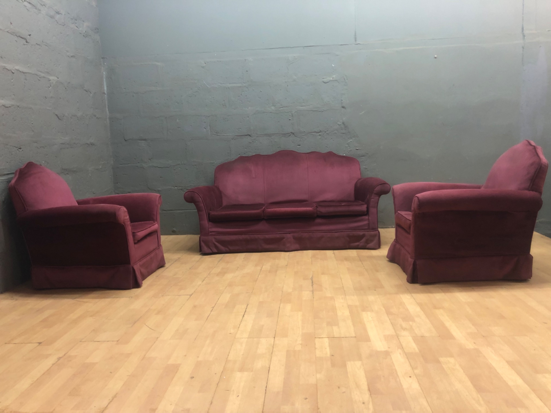 Burgundy three-piece living room suite — 3-seat sofa + 2 armchairs, velvet-look upholstery, used