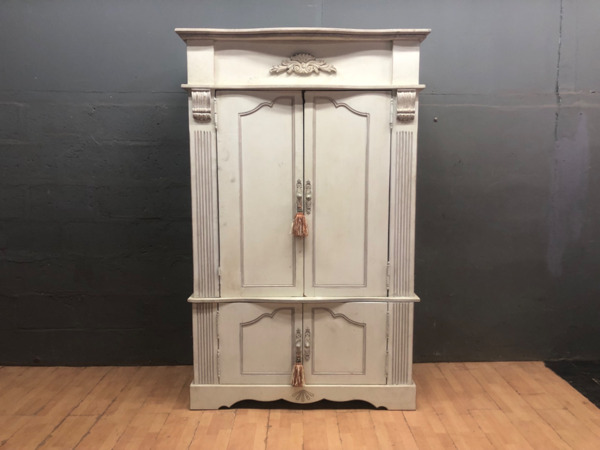 Two‑piece tall decorative painted armoire/cabinet — carved appliqué, internal shelving, cable cut-outs