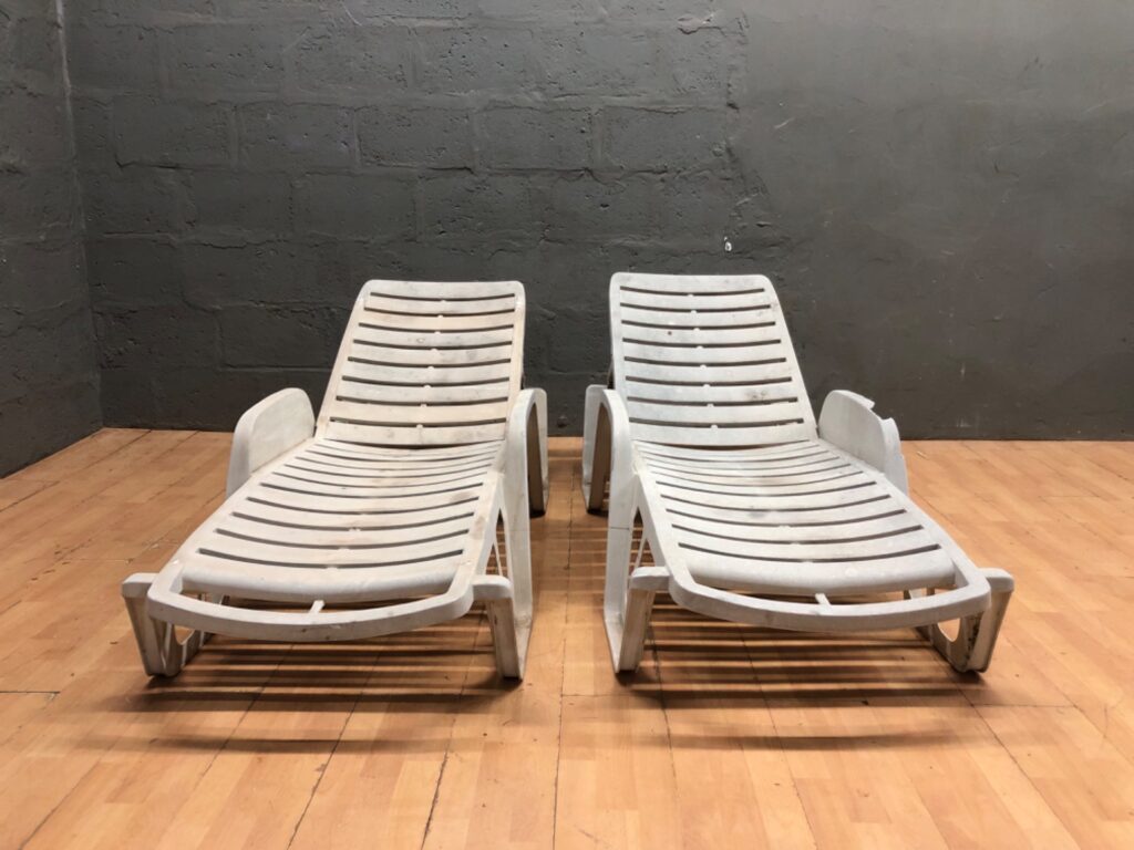 Pair of white plastic reclining sun loungers — adjustable backs, outdoor poolside style (2 pieces)