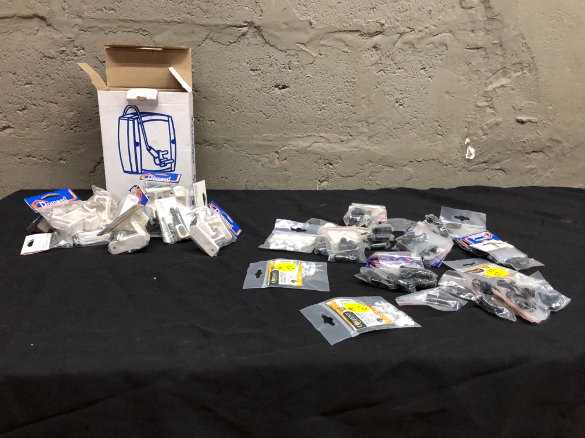 Mixed hardware lot — Domesti single curtain rail brackets (box labelled 15 packs) + Current cable clips, rubber end caps & screws (retail packaged)