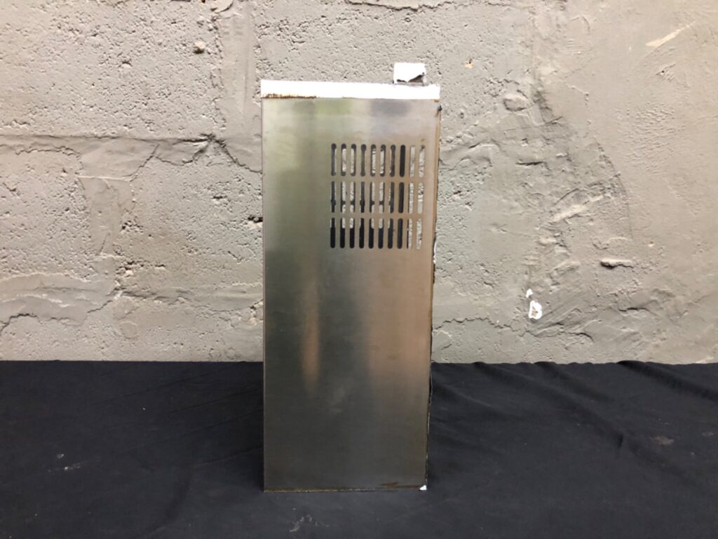Empty vented metal electronics chassis / enclosure — 18 x 45 x 20 cm — used, dents & light rust
