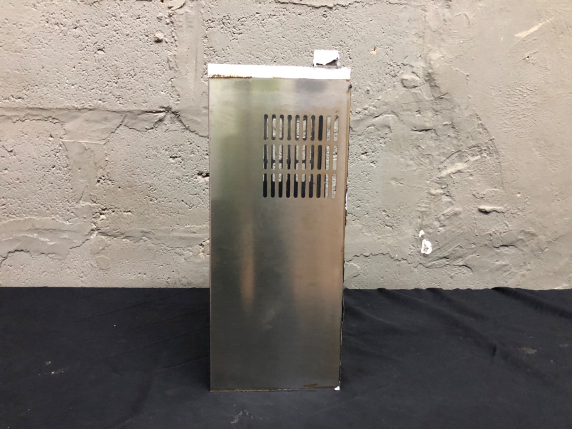 Empty vented metal electronics chassis / enclosure — 18 x 45 x 20 cm — used, dents & light rust