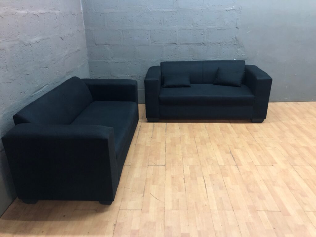 Pair of dark fabric two-seater sofas — used, good condition