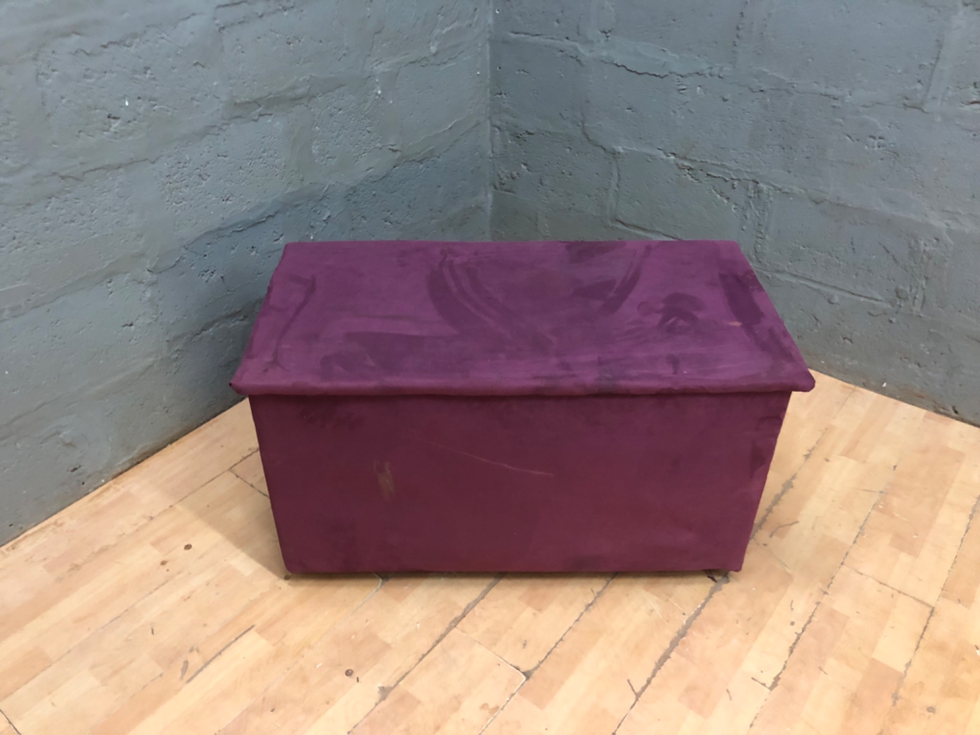 Purple fabric‑covered storage ottoman / blanket box — hinged lid, 56 x 106 x 58 cm