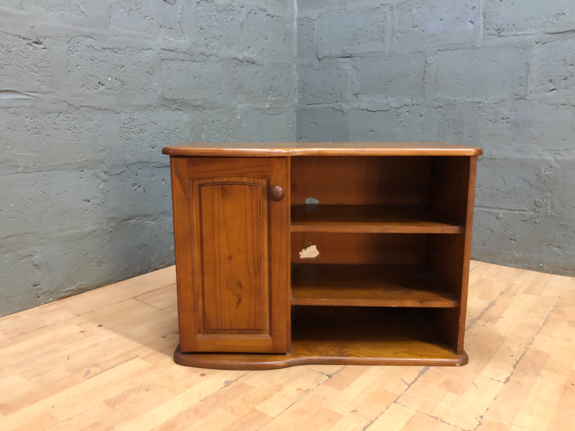 Small pine‑coloured side cabinet — single door, three open shelves, solid & stable