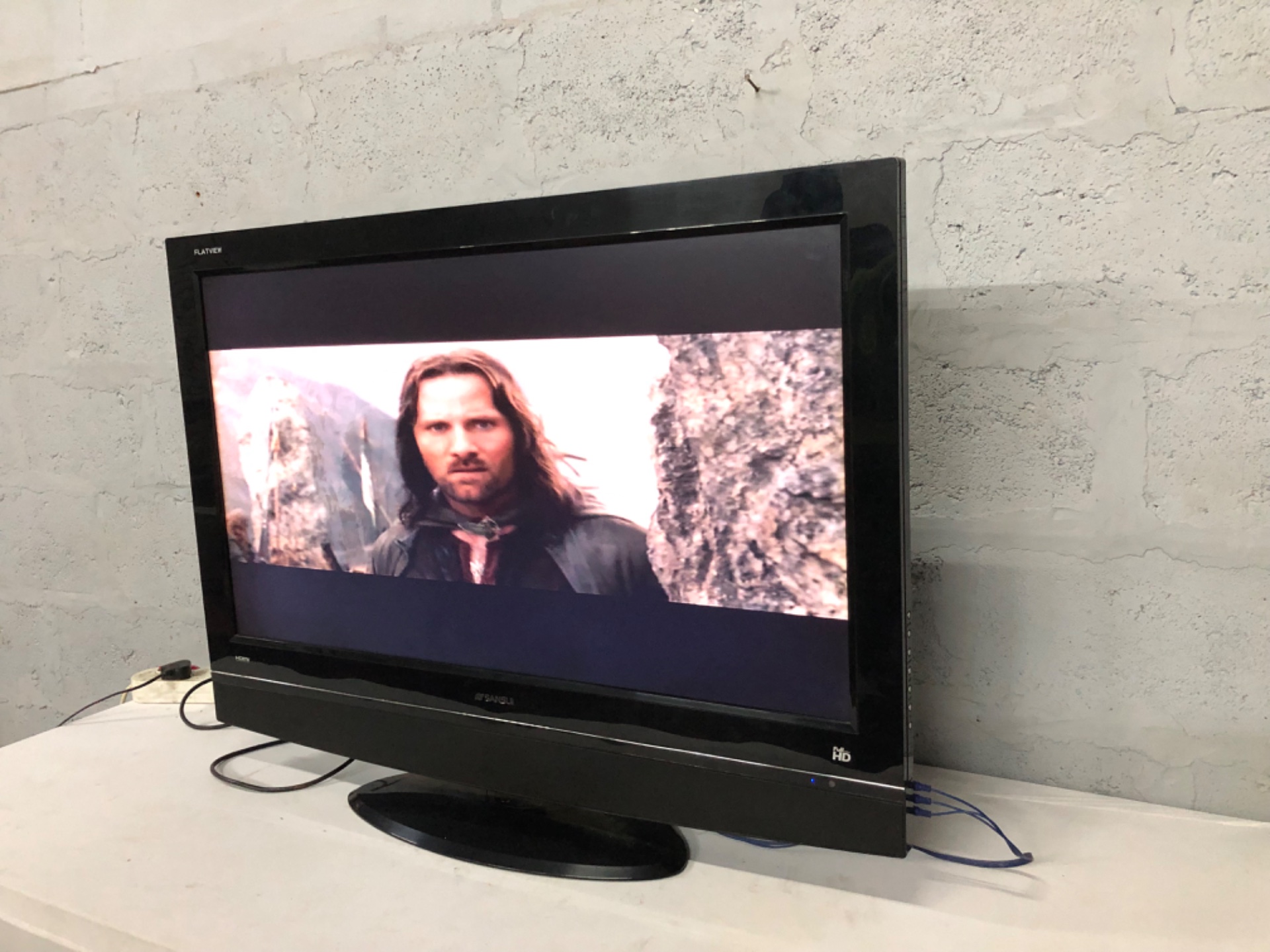Sansui 42″ LCD TV (SV-4251LCD) — powers on, built-in stand, model label visible