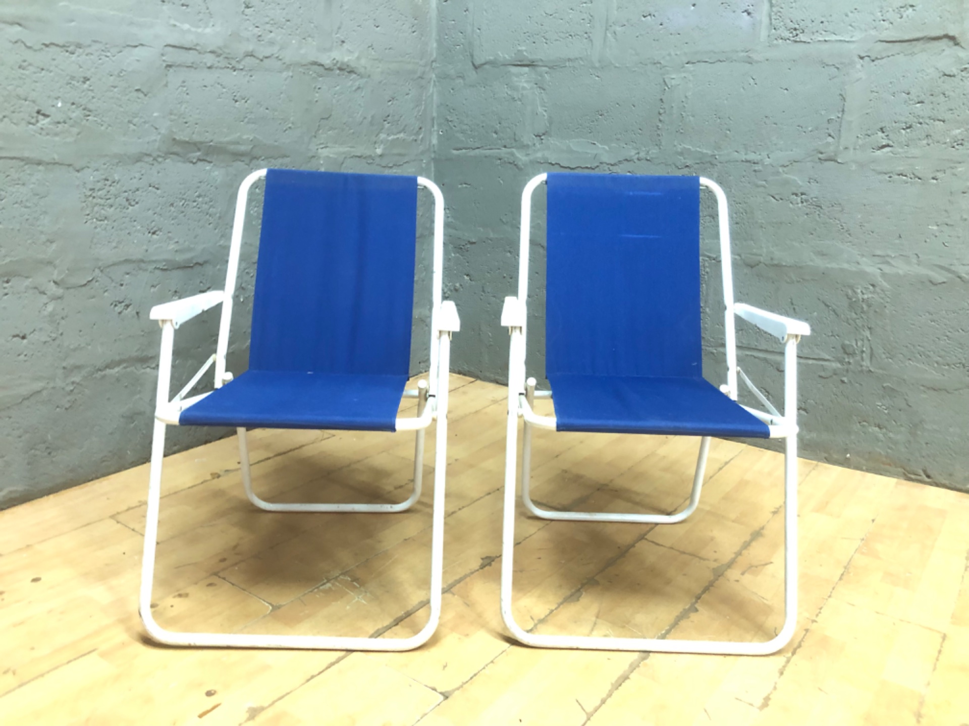 Pair of blue sling outdoor / beach chairs — white tubular frames, matching pair