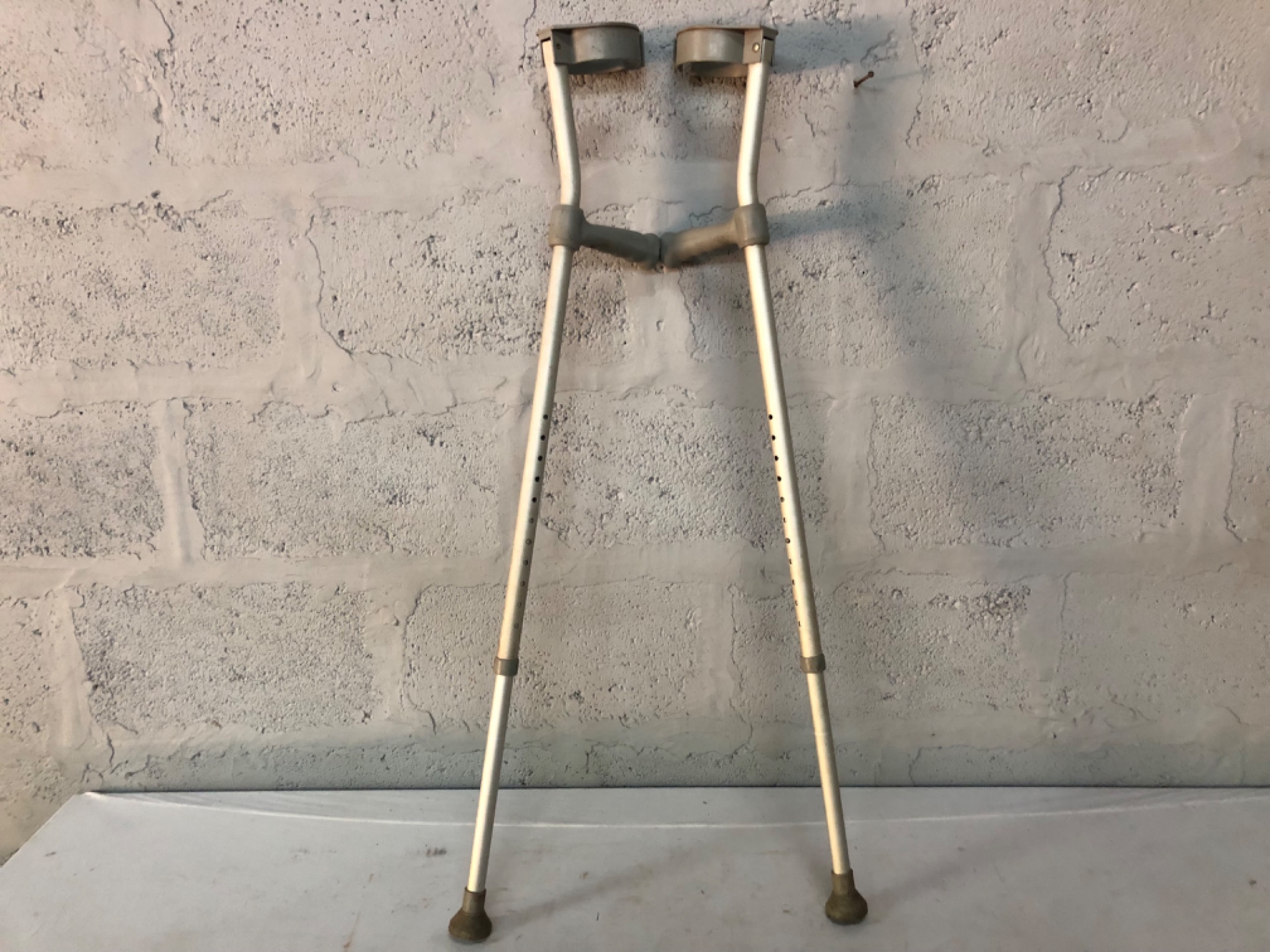 Pair of adjustable aluminium underarm crutches — used, adjustable height, rubber tips fitted