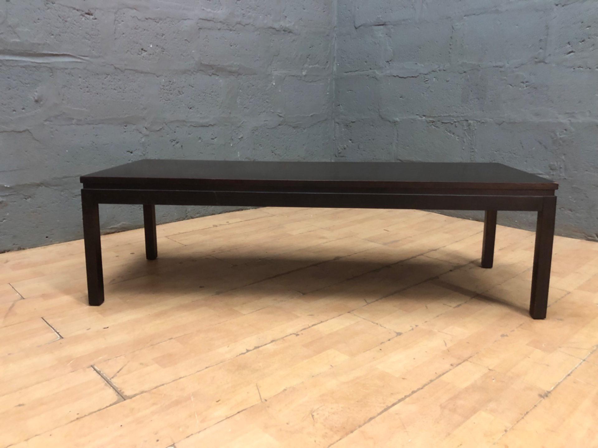 Low rectangular coffee / occasional table — dark finish, 137 × 51 × 41 cm — surface crazing and corner chip