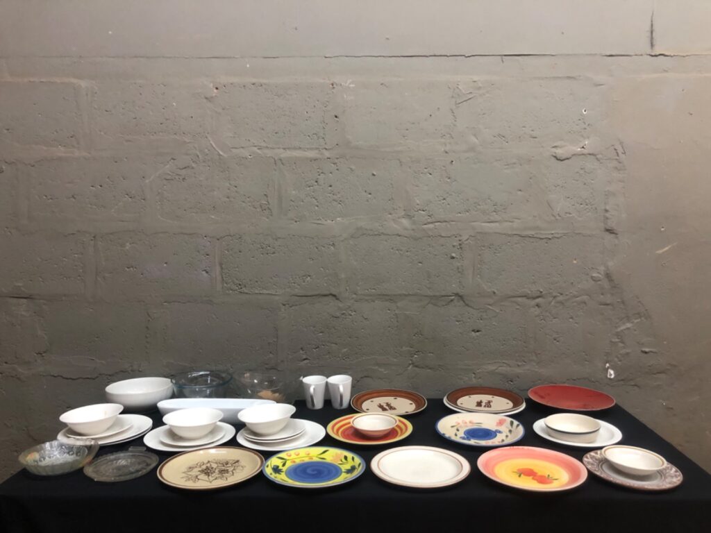Mixed lot — approx. 35 dinnerware & serving pieces (plates, bowls, glassware, mugs) — used, needs light clean