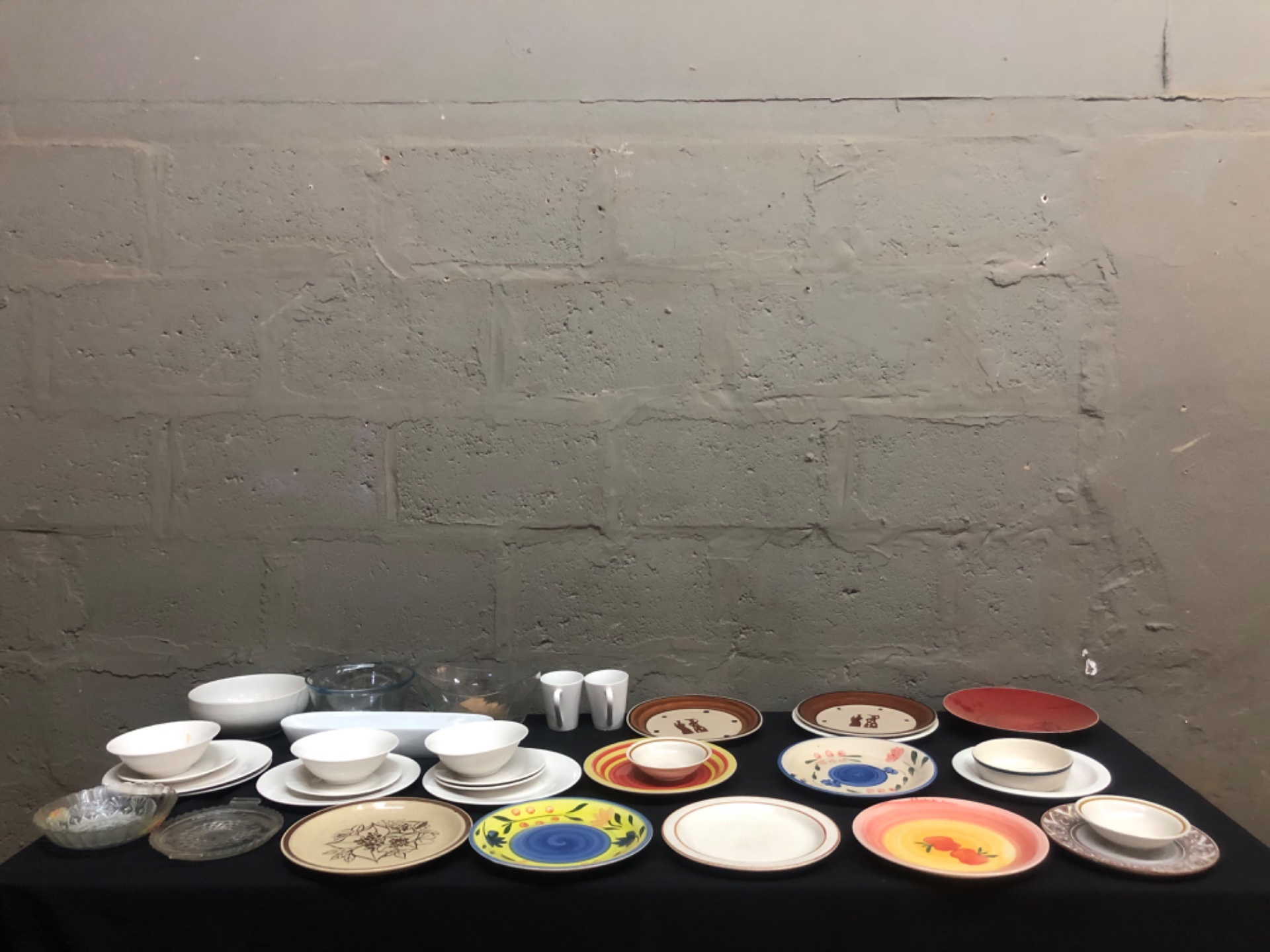 Mixed lot — approx. 35 dinnerware & serving pieces (plates, bowls, glassware, mugs) — used, needs light clean
