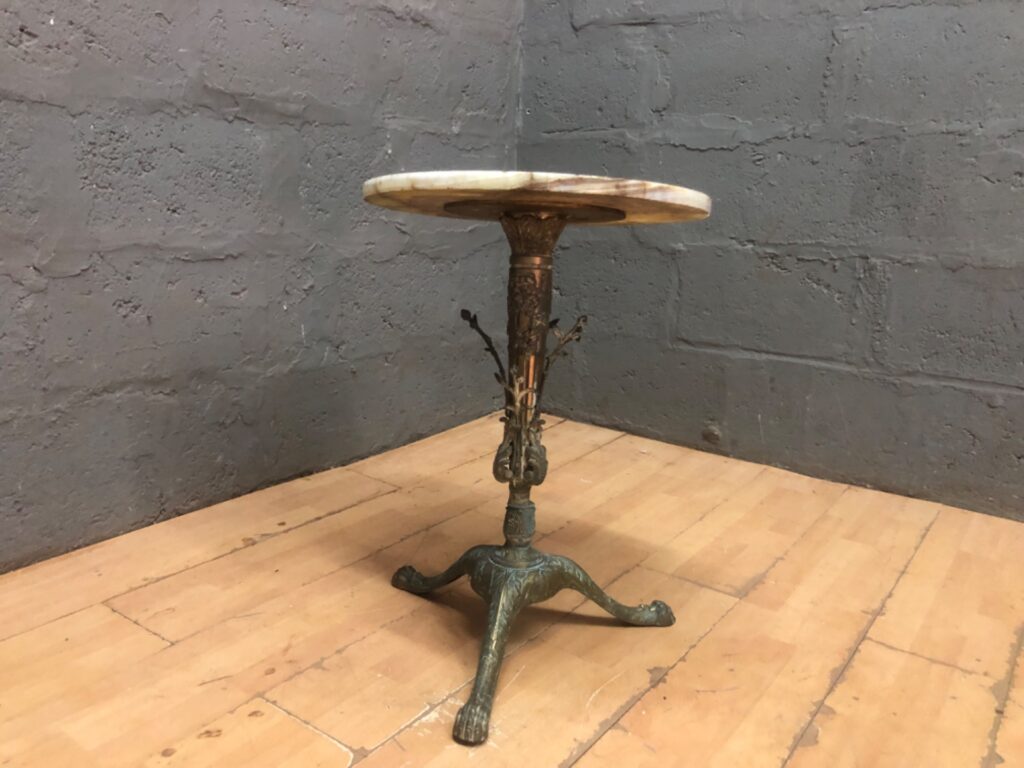 Ornate cast-metal tripod occasional table with veined stone top