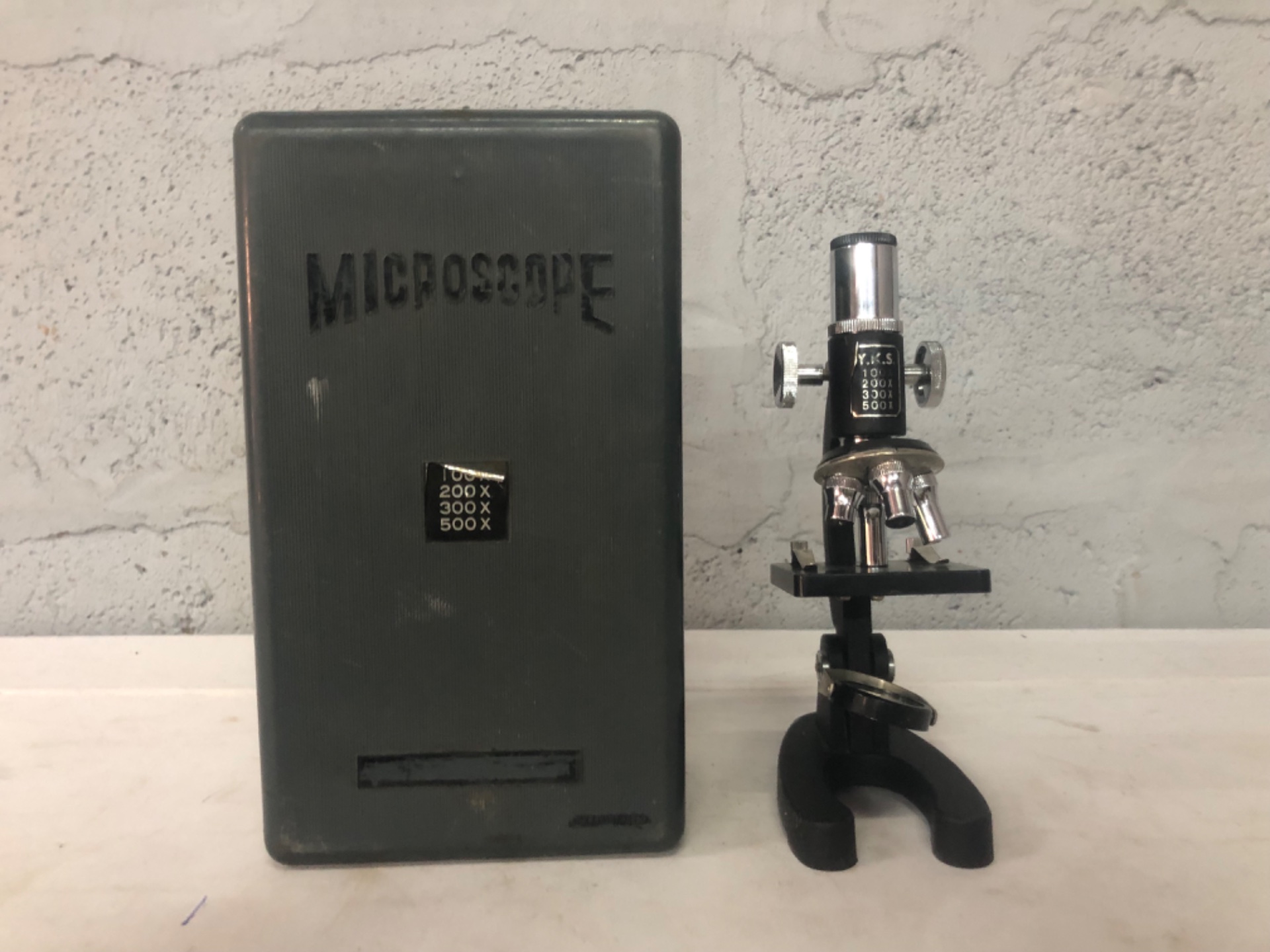 Y.K.S. marked student microscope (100x/200x/300x/500x) with plastic storage case