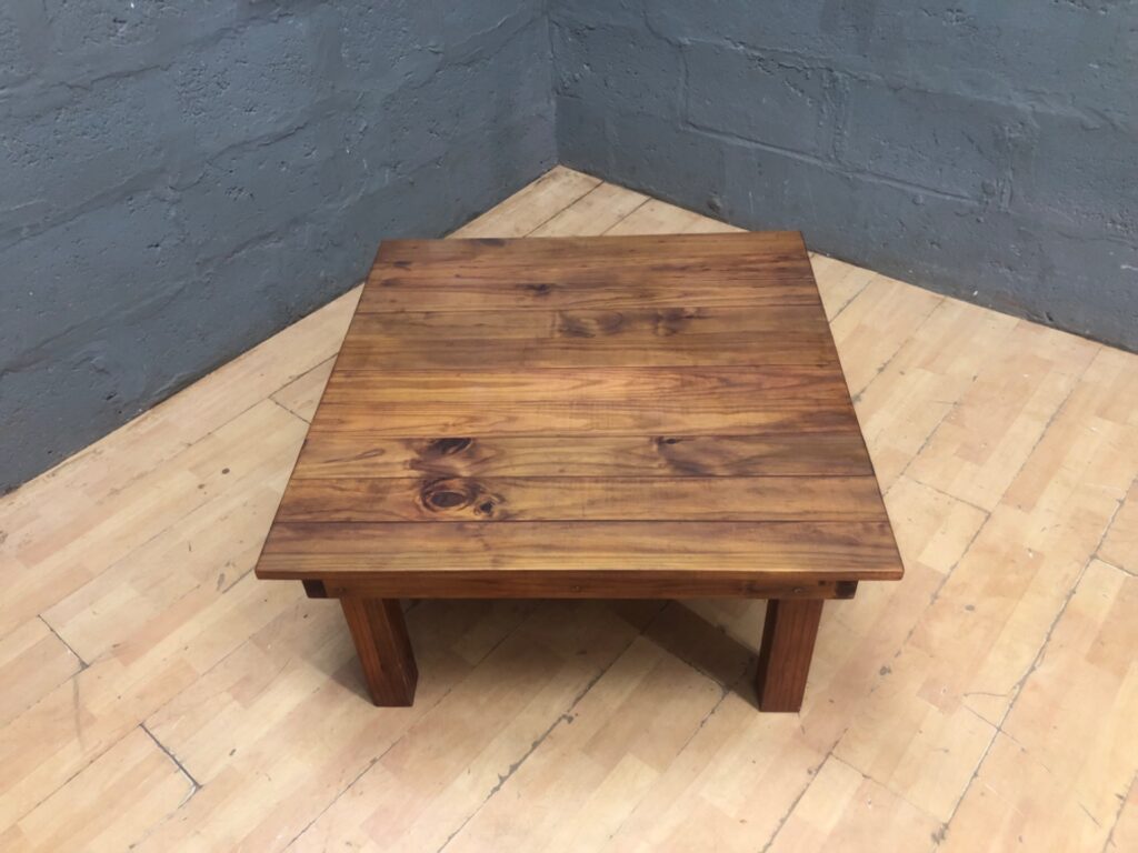 Solid timber low coffee table — plank top with natural knots, 93 × 90 × 47 cm