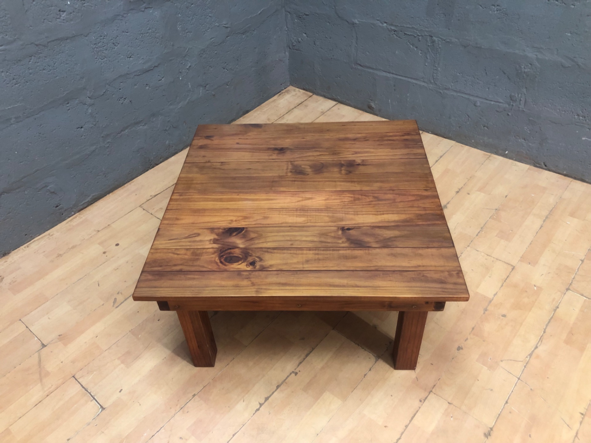 Solid timber low coffee table — plank top with natural knots, 93 × 90 × 47 cm