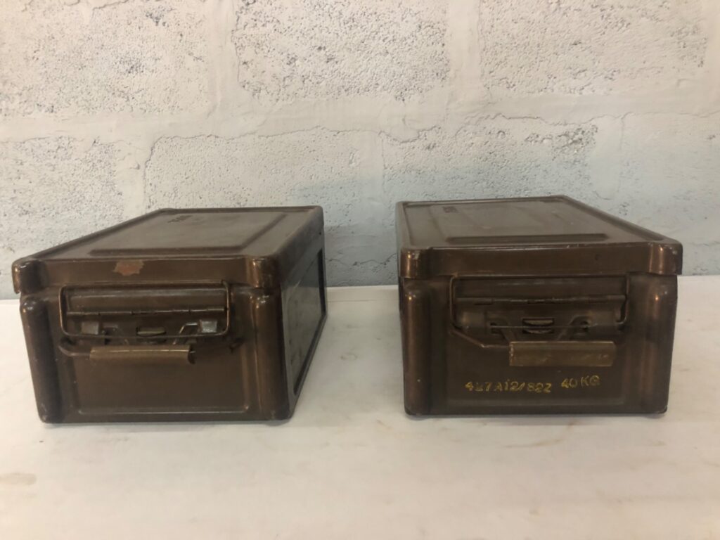 Pair of metal military-style storage / ammo boxes — hinged lids, stamped codes, original latches & gaskets