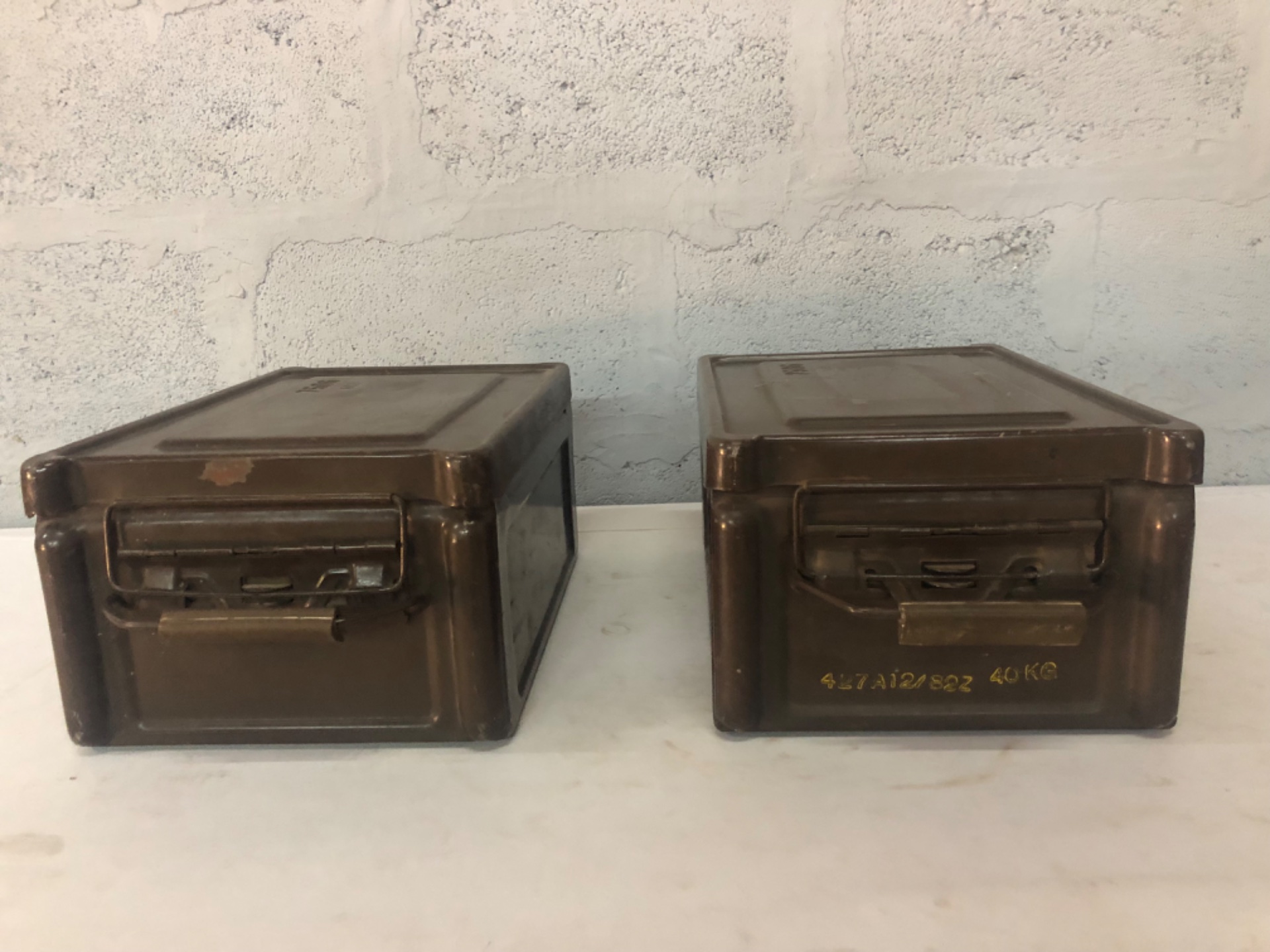Pair of metal military-style storage / ammo boxes — hinged lids, stamped codes, original latches & gaskets